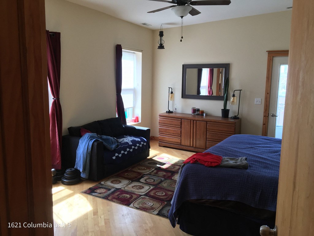 a bedroom with two beds and a dresser and a mirror