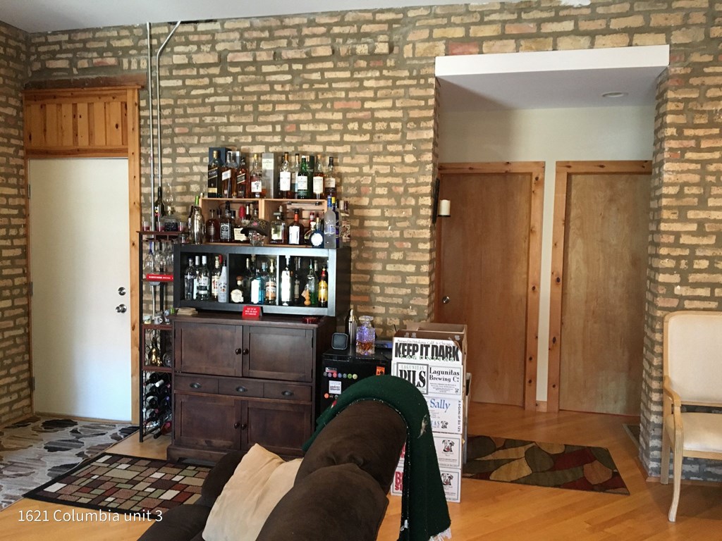 a living room with a couch and a liquor cabinet
