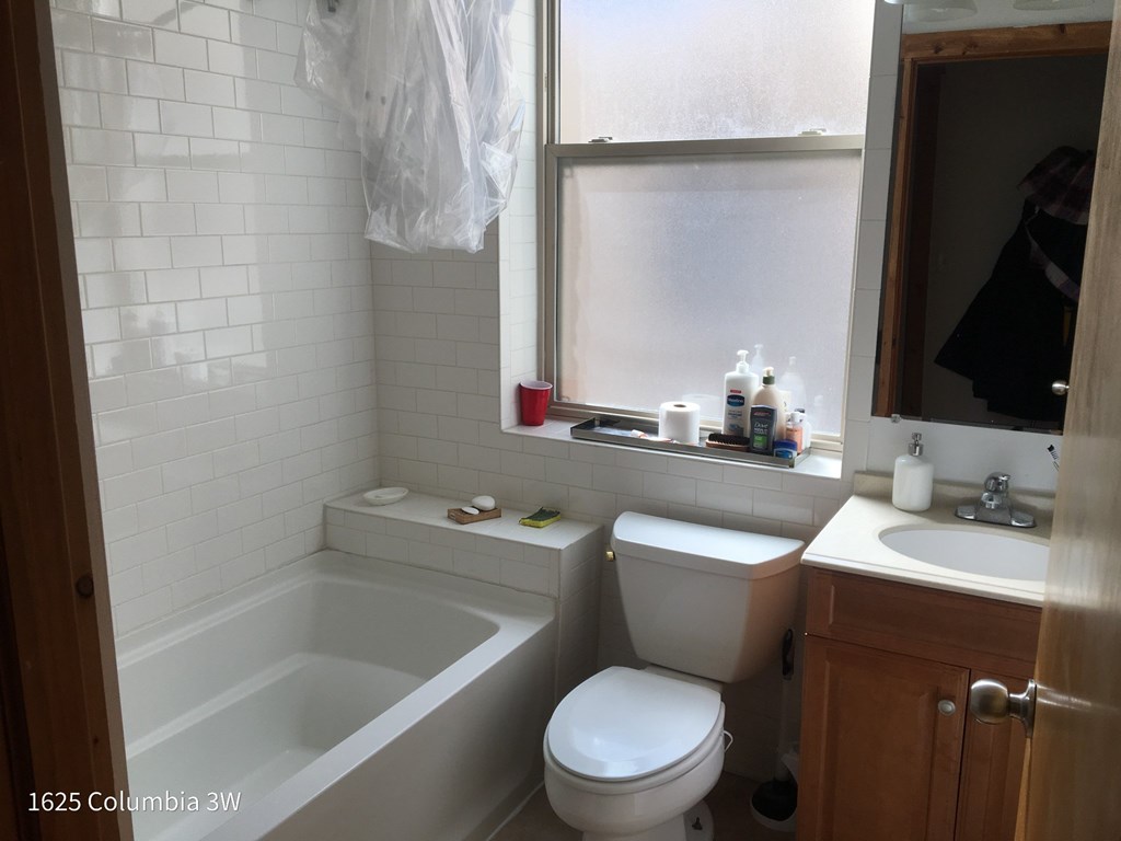a small bathroom with a toilet sink and bath tub