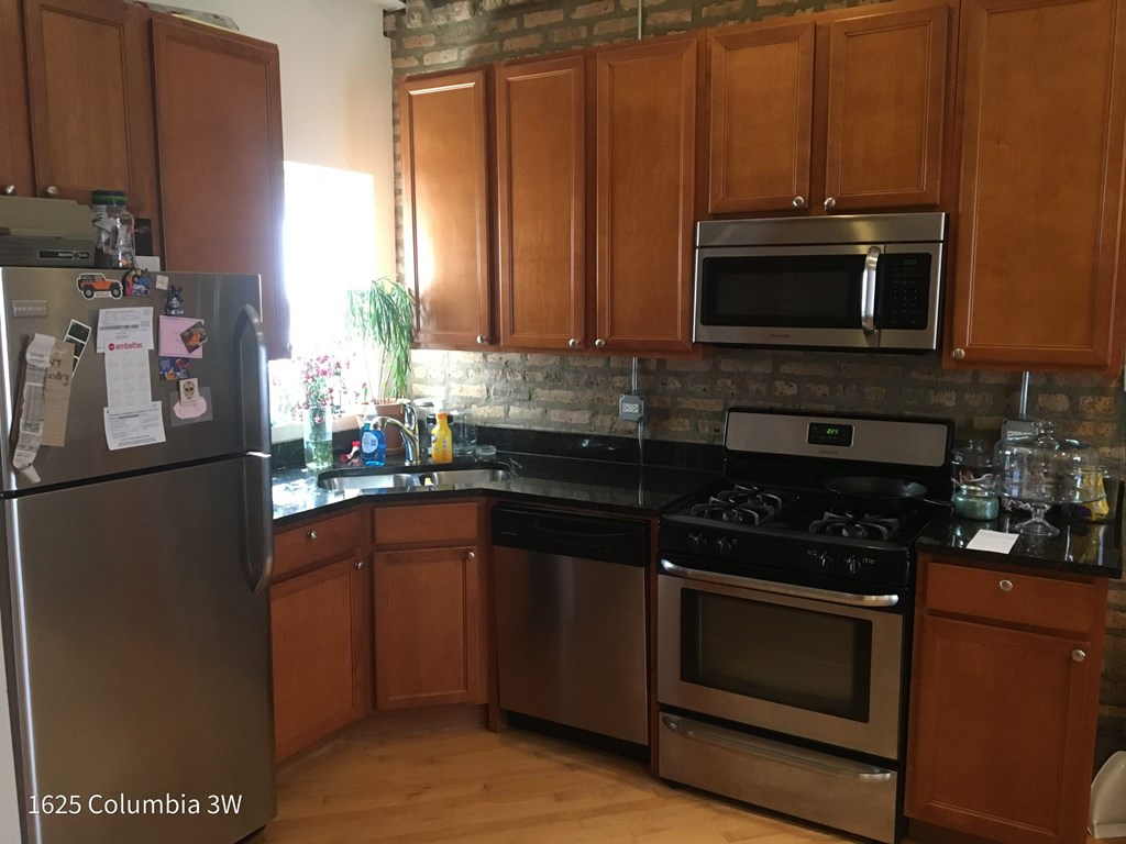 a kitchen with stainless steel appliances and wooden cabinets