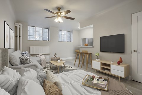 A living room with a white couch and a wooden coffee table.
