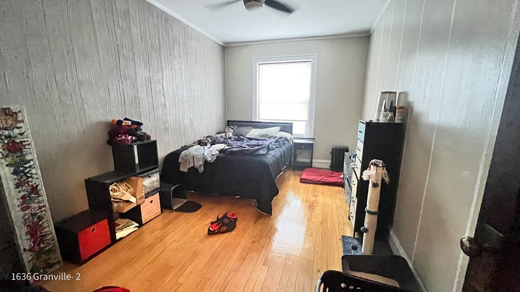 a bedroom with a bed and a dresser and a window