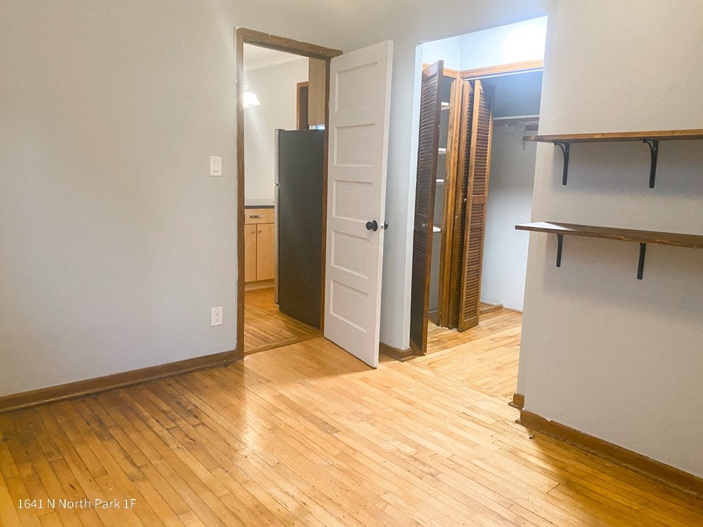 a living room with hardwood floors and white walls