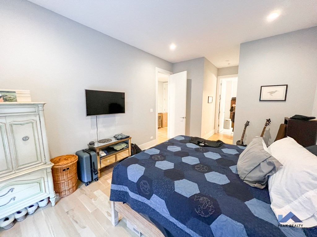 a bedroom with a bed and a tv