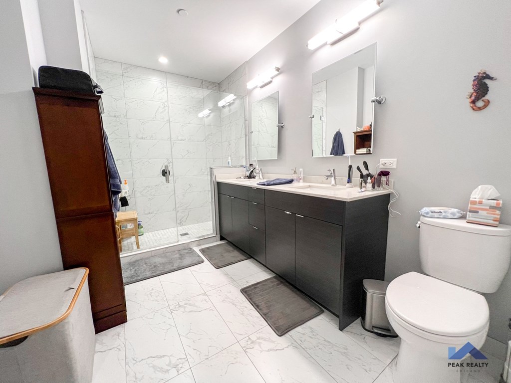 a bathroom with a toilet sink and shower