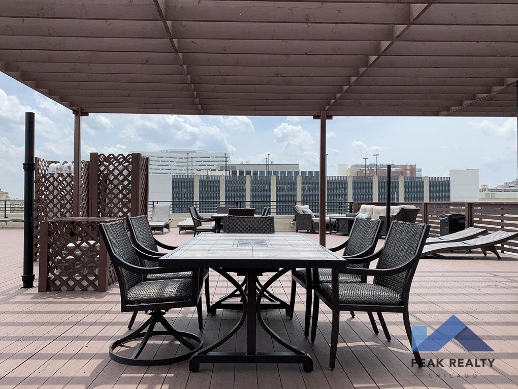 a table and chairs on a roof terrace with a view of the city