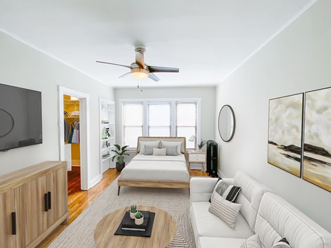 A living room with a white couch and a wooden coffee table.