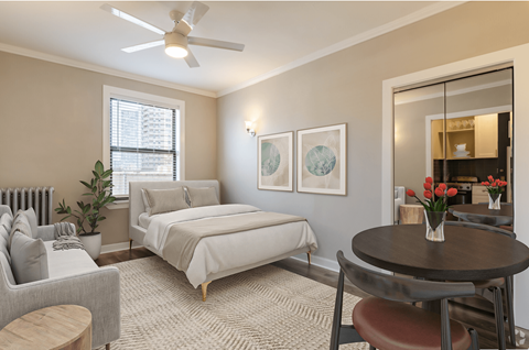a bedroom with a bed and a living room with a couch and a table