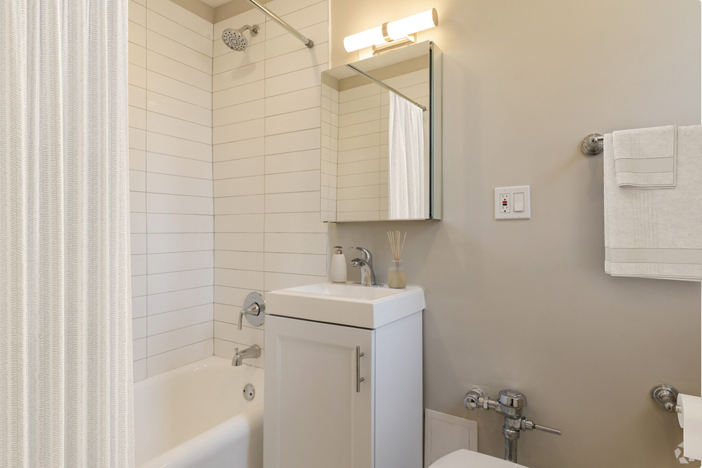 a small bathroom with a sink and a bath tub