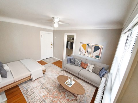 A living room with a couch, a coffee table, and a rug.
