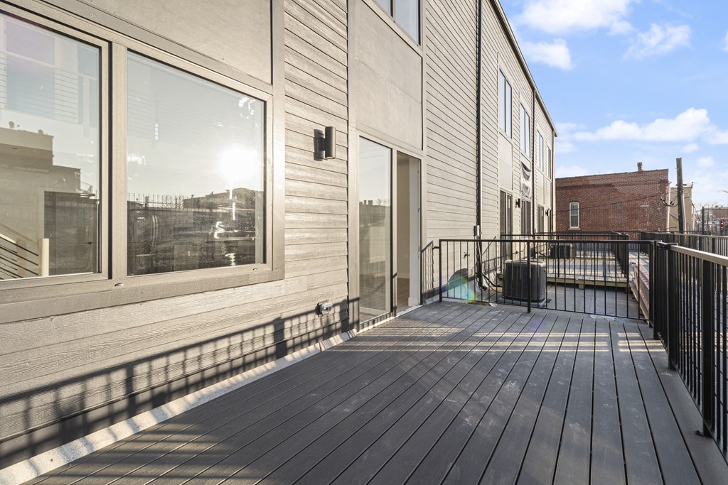 the deck of a building with a balcony and a view of the city