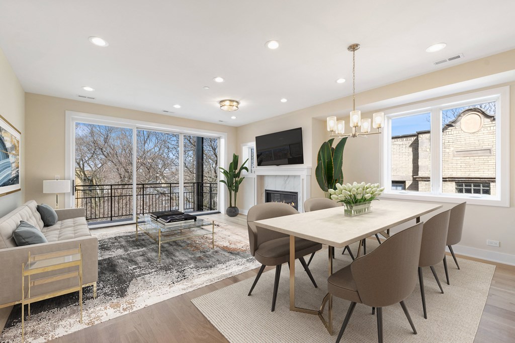 a living room with a table and chairs and a fireplace