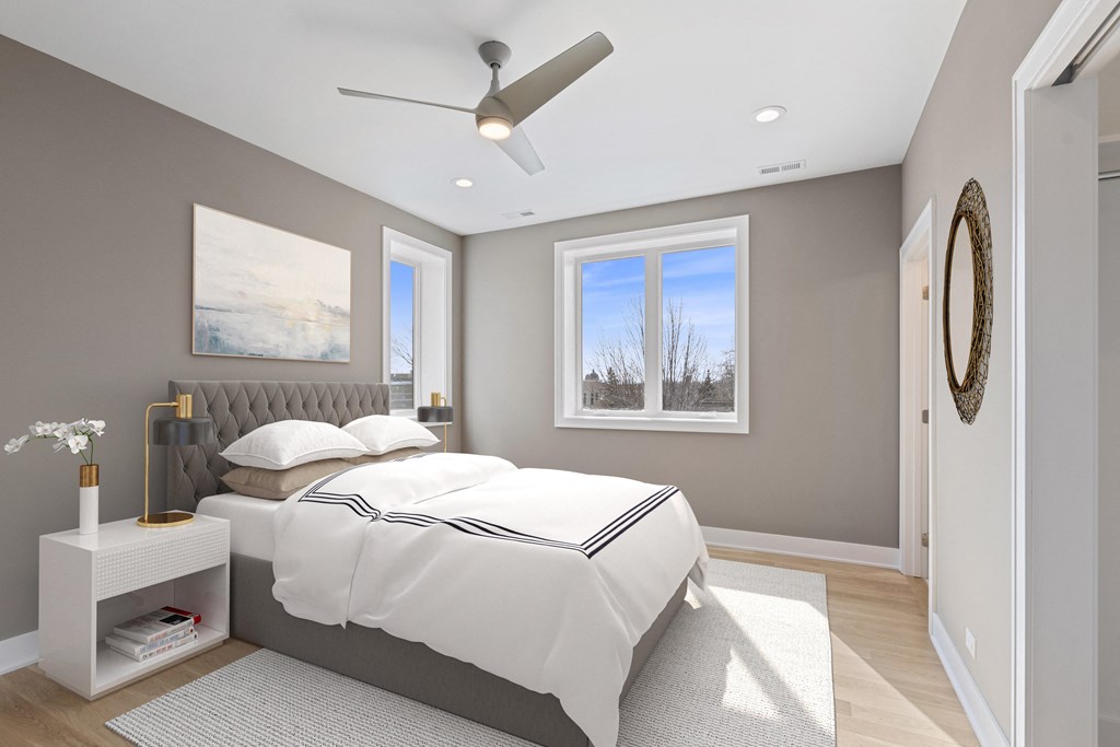 a bedroom with a bed and a ceiling fan