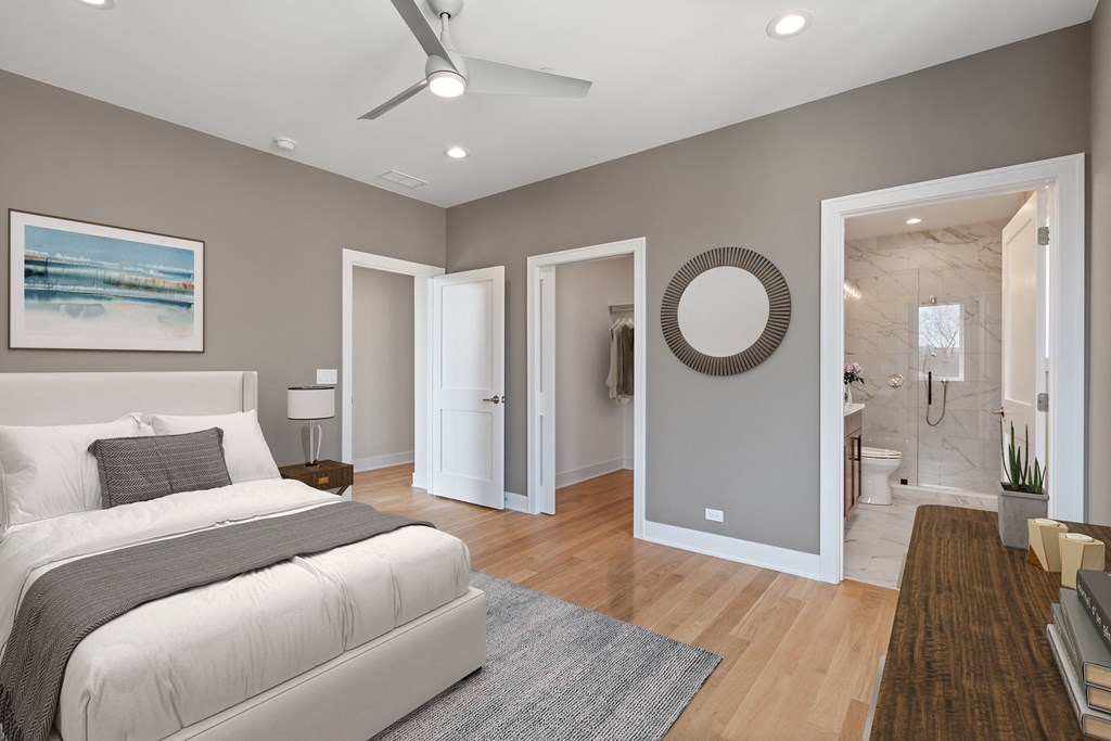 a bedroom with a white bed and a bathroom