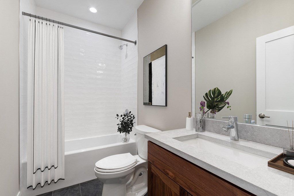 a bathroom with a sink and a toilet and a shower