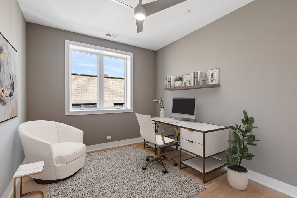 an office with a desk and a chair and a window