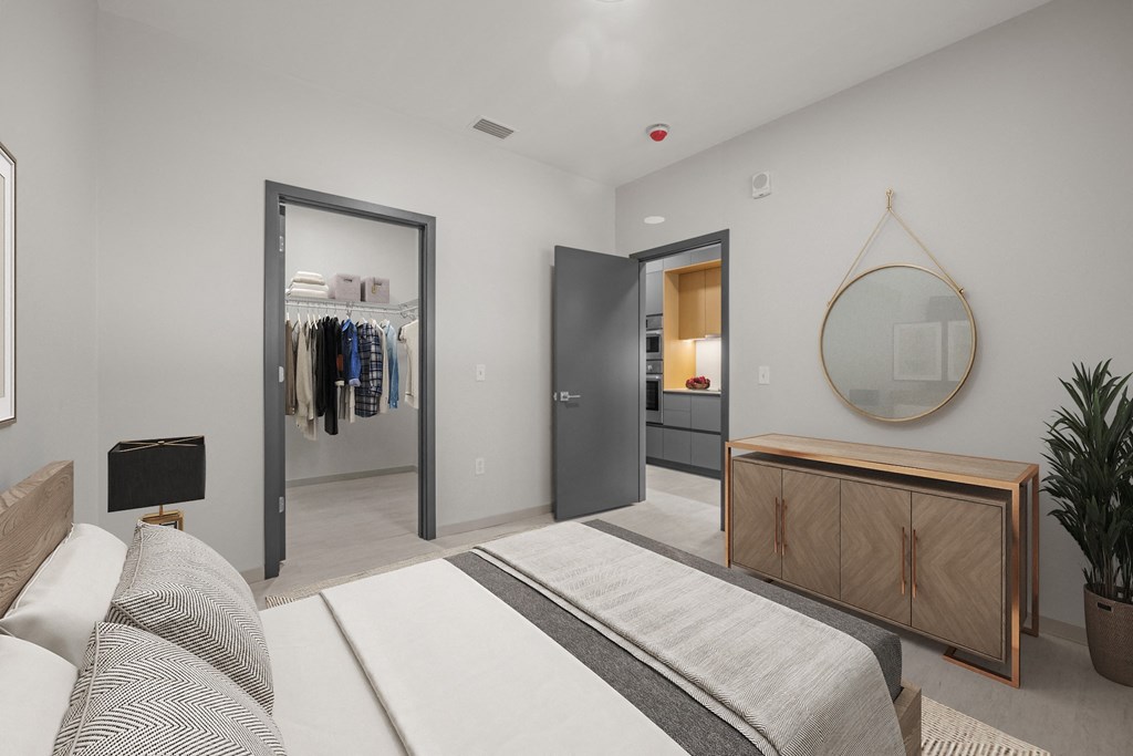a bedroom with a bed and a closet and a mirror