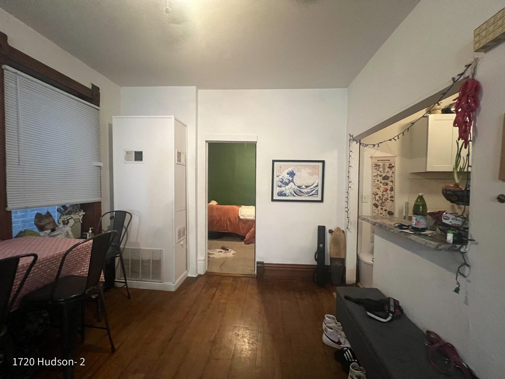 a living room and dining room with a door to a bedroom
