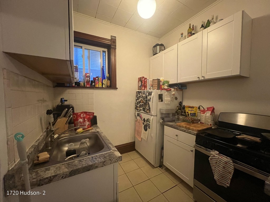 a kitchen with a sink and a stove and a refrigerator