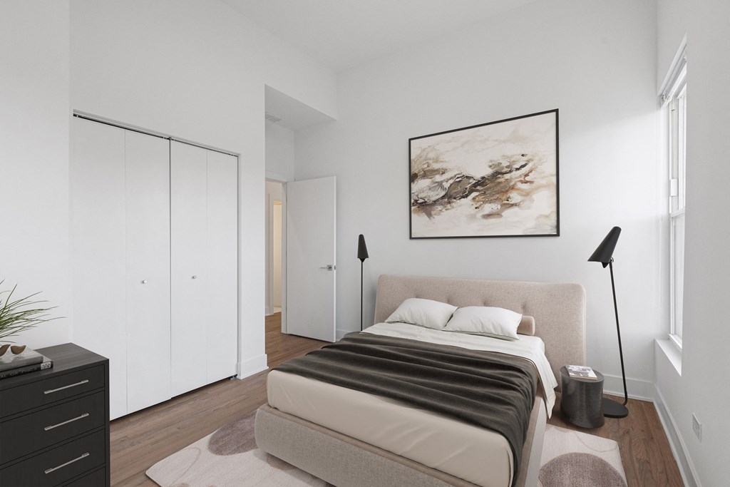 a bedroom with a bed and a painting on the wall