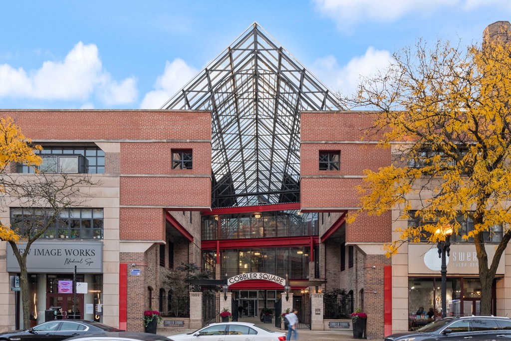 the front of a building with a glass pyramid on top of it