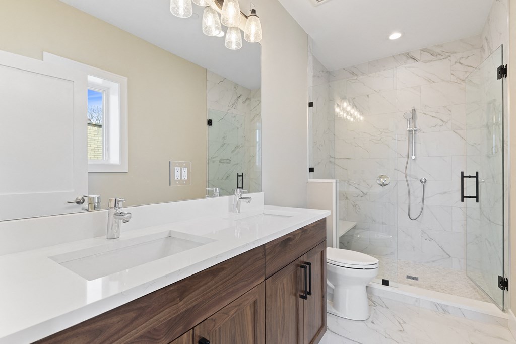 a bathroom with a sink and a shower and a toilet