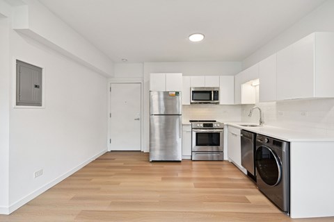 A kitchen with white cabinets and stainless steel appliances.