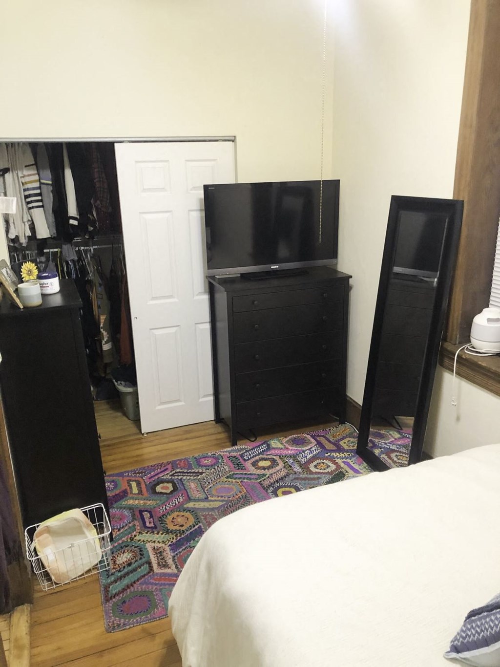 a small room with a bed and a television in it