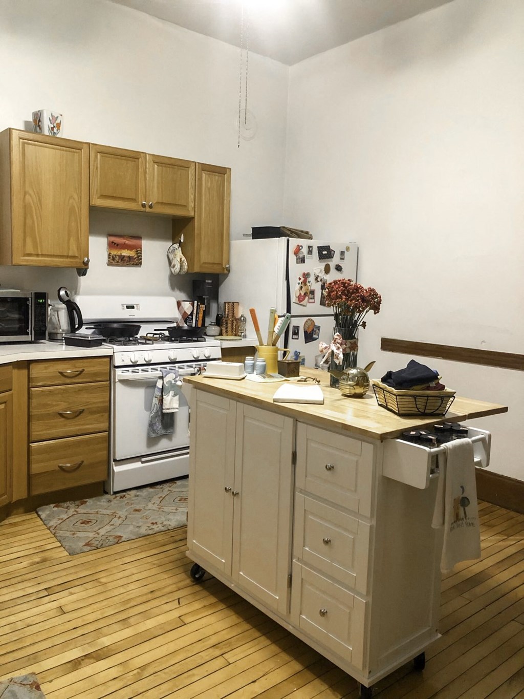 a kitchen with white appliances and wooden cabinets