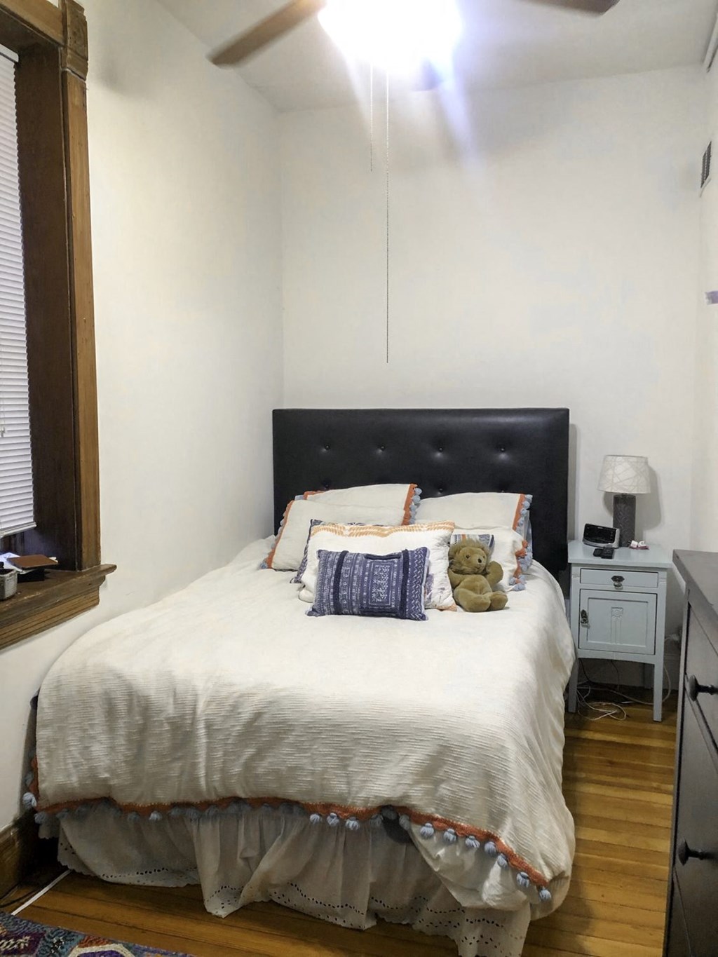 a bedroom with a bed and a window