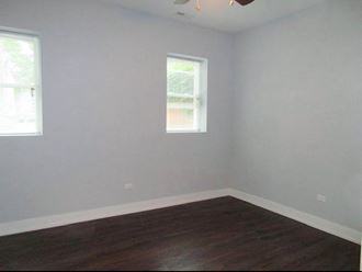 an empty room with a window and a ceiling fan - Photo Gallery