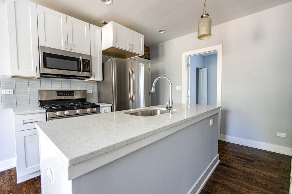 a kitchen with a large counter top and a sink