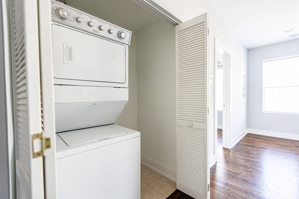 a white washer and dryer in a room with a door