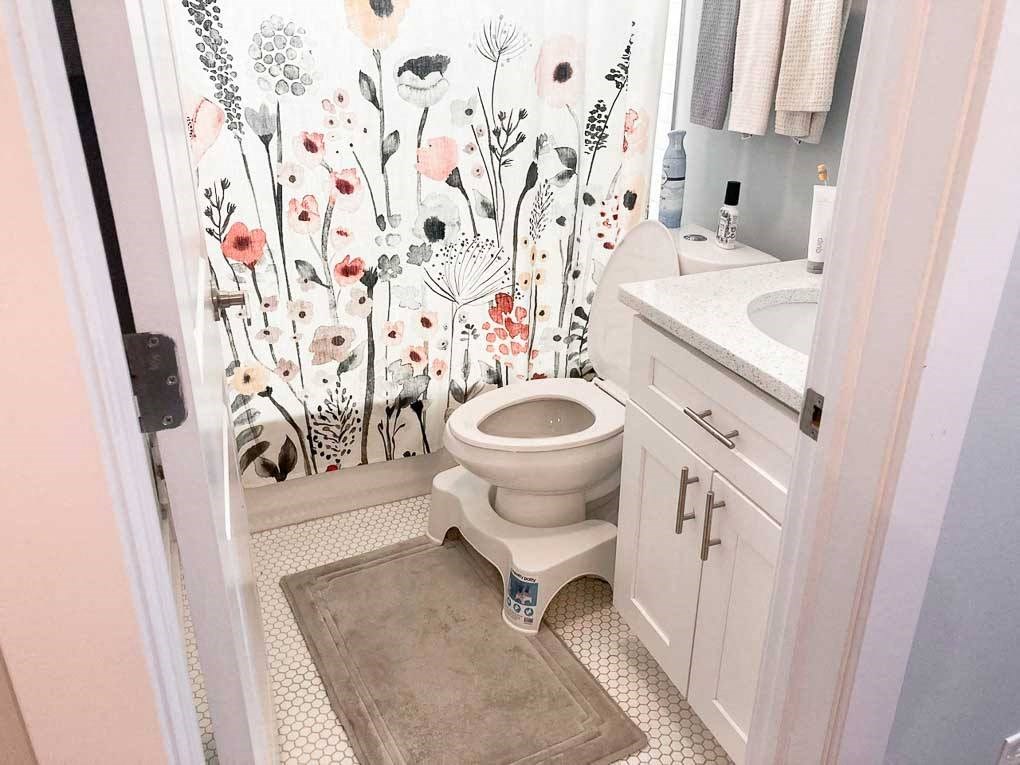 a bathroom with a toilet and a sink and a shower