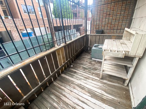A wooden deck with a table and chairs on it.