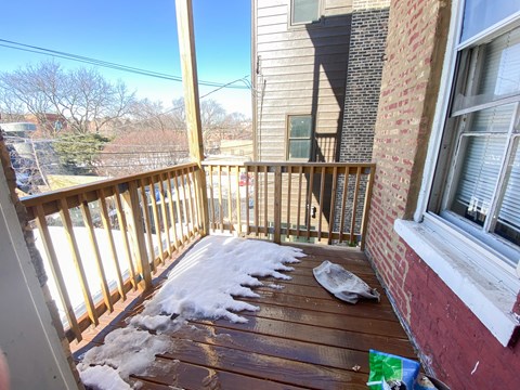A wooden deck with snow on it.