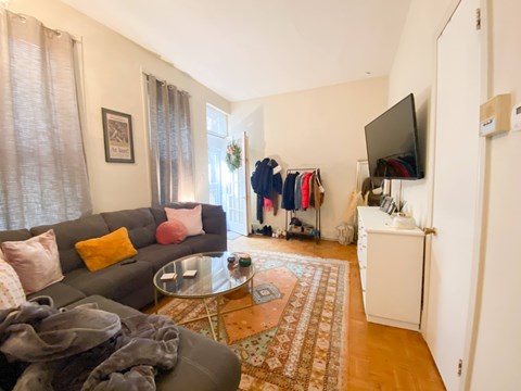 A living room with a grey couch and a coffee table.