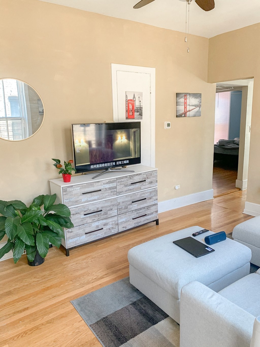 a living room with a couch and a television on a dresser
