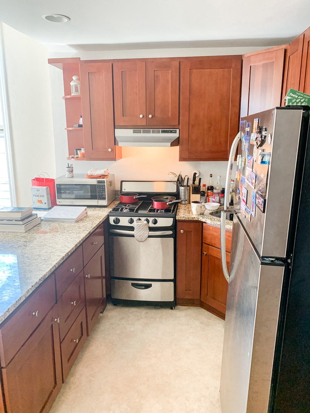 a kitchen with wooden cabinets and stainless steel appliances