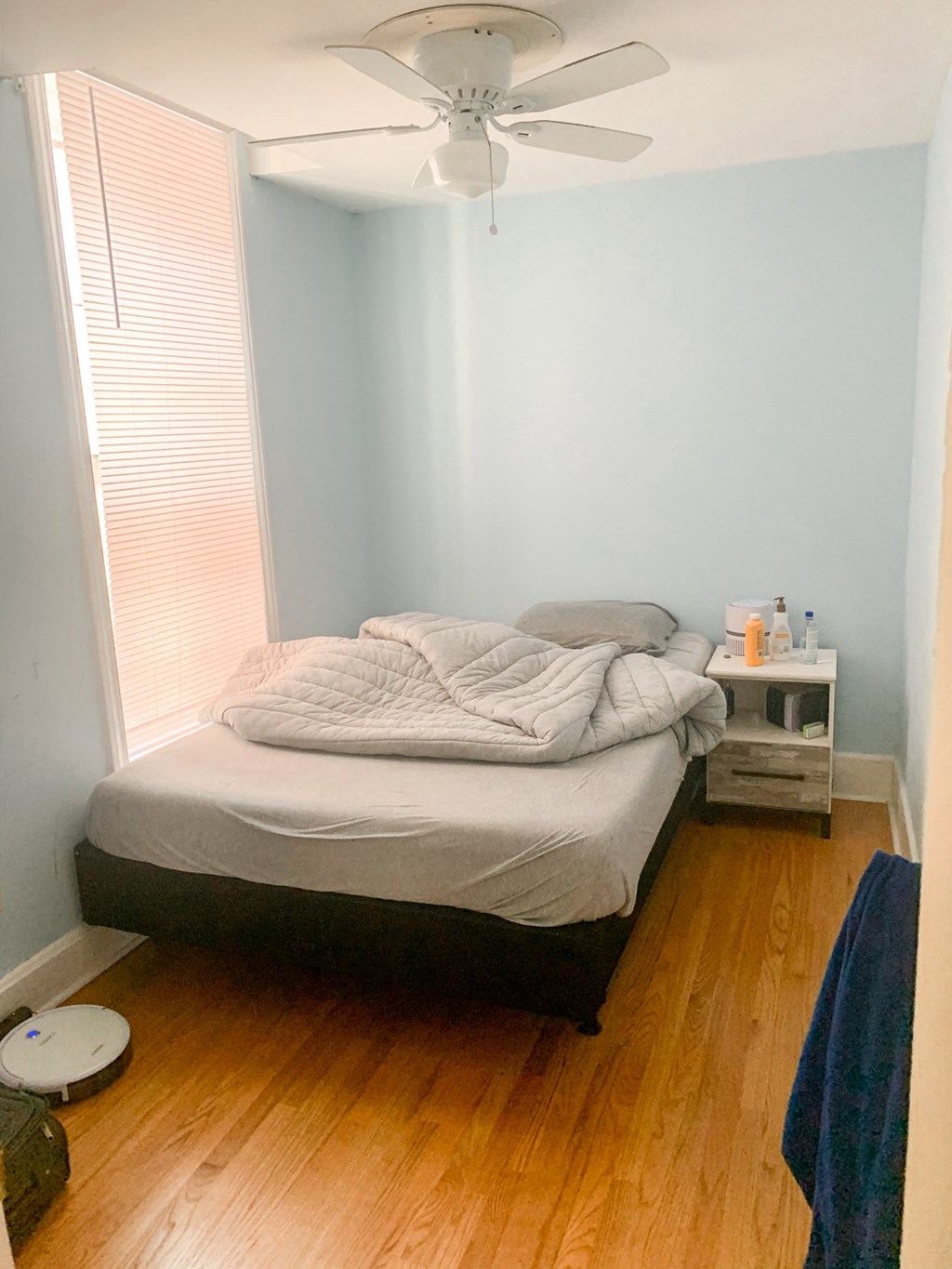 a bedroom with a bed and a ceiling fan