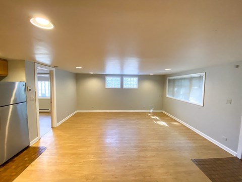 A kitchen with a refrigerator and a window.