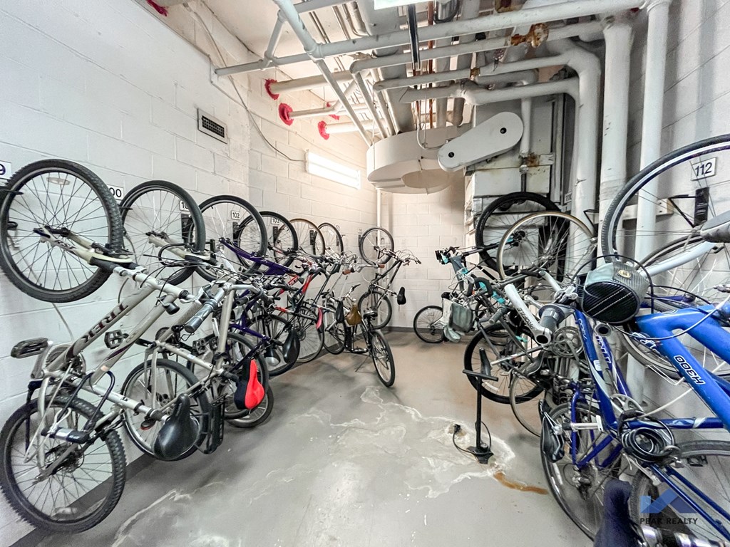 a bunch of bikes parked in a room with white walls