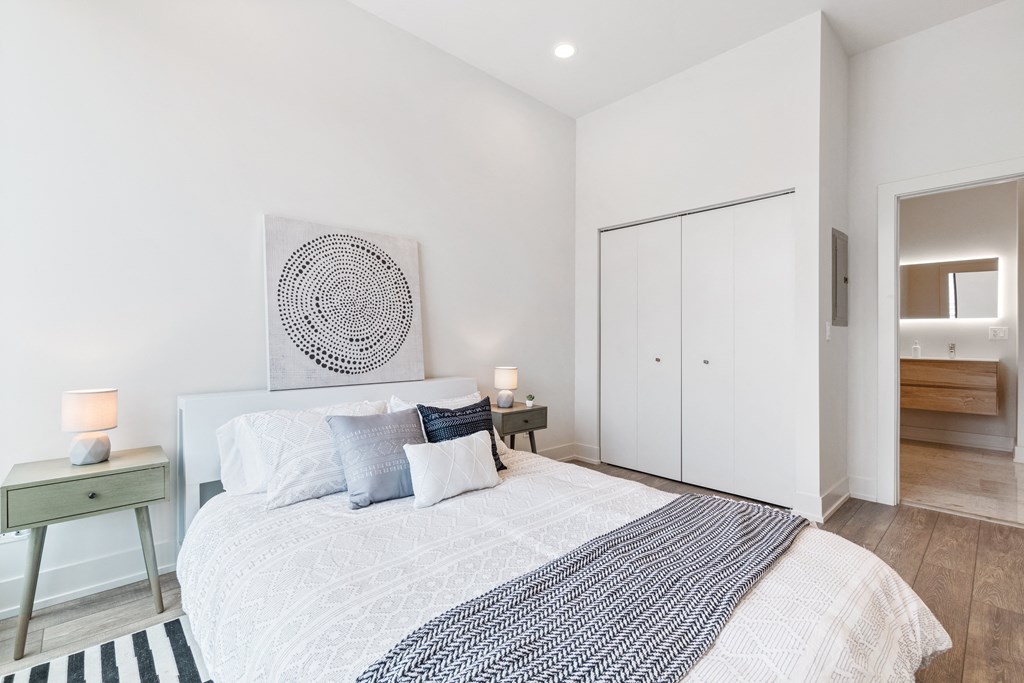 A bedroom with a bed and two night stands