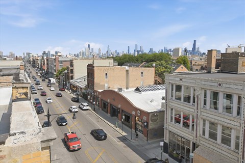A city street with cars and buildings.