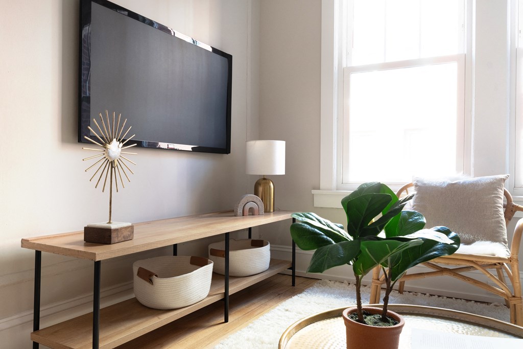 a living room with a couch and a tv on the wall