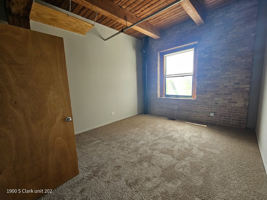 an empty room with a door and a window
