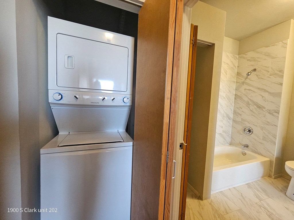 a small bathroom with a washer and dryer in it