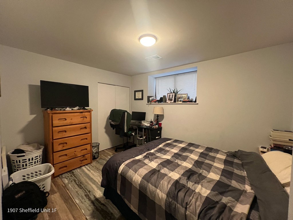 a small bedroom with a bed and a tv