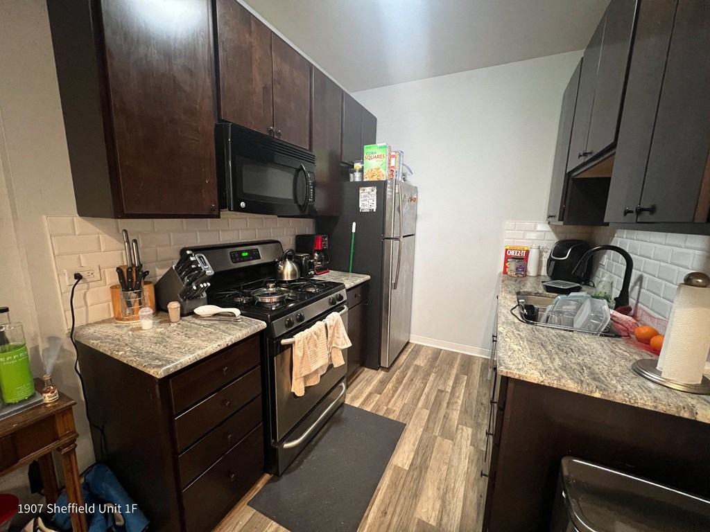 a kitchen with stainless steel appliances and wooden cabinets