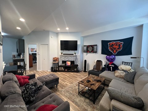 a living room with couches and a fireplace and a tv